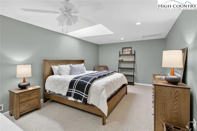 a bedroom with a bed and a lamp