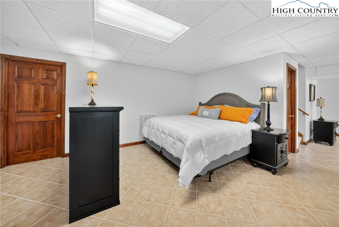 233 Lakeview Place, Unit D2 Jefferson, NC 28640 - Photo 34 of 49 a bedroom with a bed and wooden floor