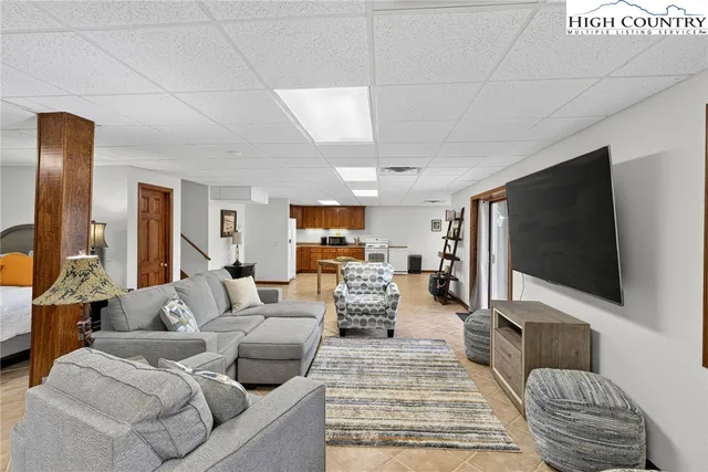 a bedroom with furniture and a flat screen tv
