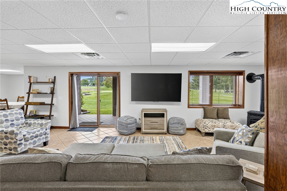 233 Lakeview Place, Unit D2 Jefferson, NC 28640 - Photo 37 of 49 a living room with furniture a flat screen tv and a large window