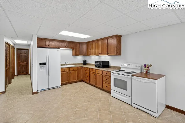 a kitchen with a refrigerator and a stove