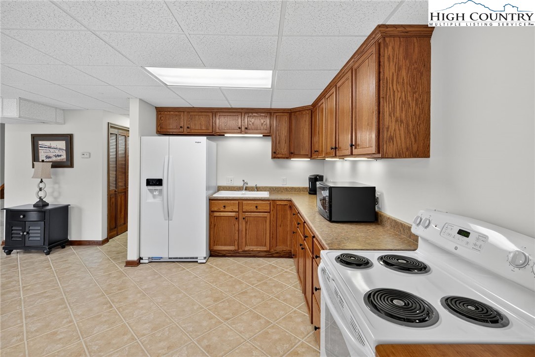 233 Lakeview Place, Unit D2 Jefferson, NC 28640 - Photo 42 of 49 a kitchen with a refrigerator and a stove