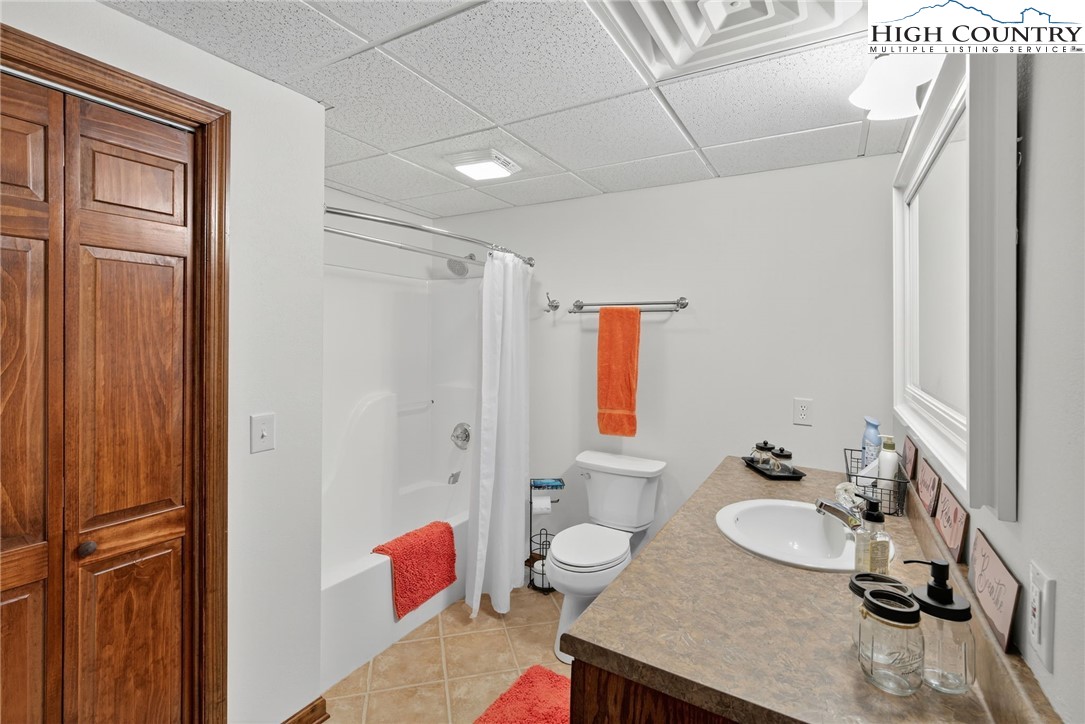 233 Lakeview Place, Unit D2 Jefferson, NC 28640 - Photo 43 of 49 a bathroom with a granite countertop sink and a mirror