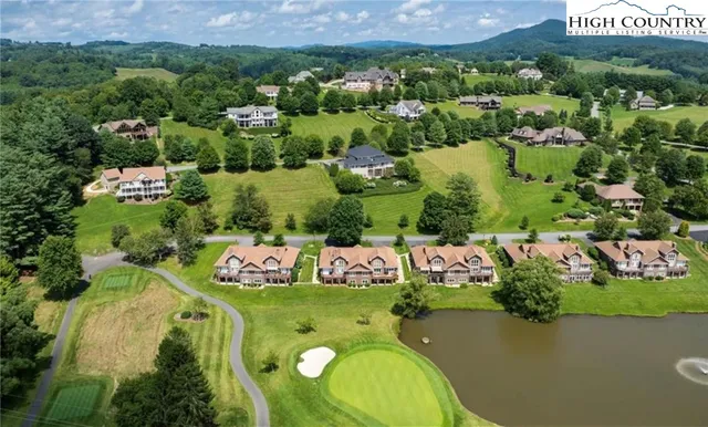 a view of a house with swimming pool and yard