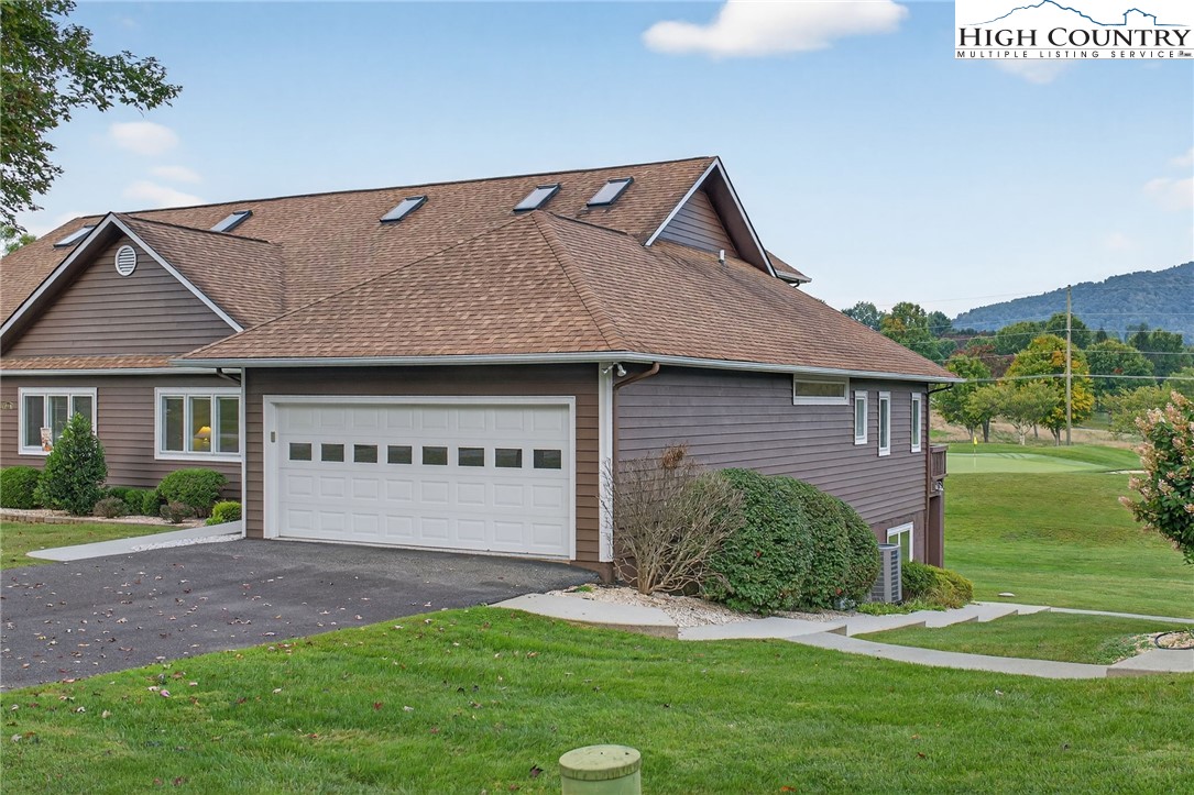 233 Lakeview Place, Unit D2 Jefferson, NC 28640 - Photo 6 of 49 a front view of a house with a yard