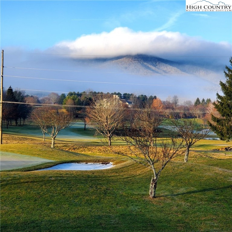 233 Lakeview Place, Unit D2 Jefferson, NC 28640 - Photo 7 of 49 a view of a swimming pool with an outdoor seating and a garden