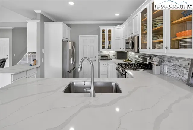 a kitchen with stainless steel appliances granite countertop a sink and cabinets