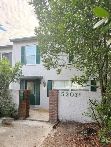 a view of a house with a tree