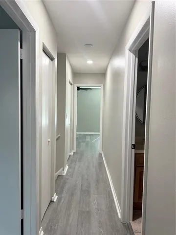 a view of a hallway with wooden floor