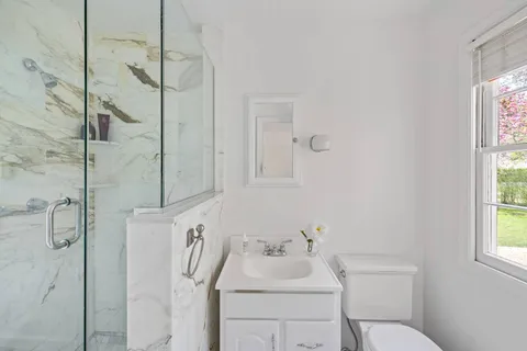 a bathroom with a sink toilet and shower