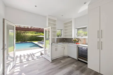 a room with kitchen island a large window in it