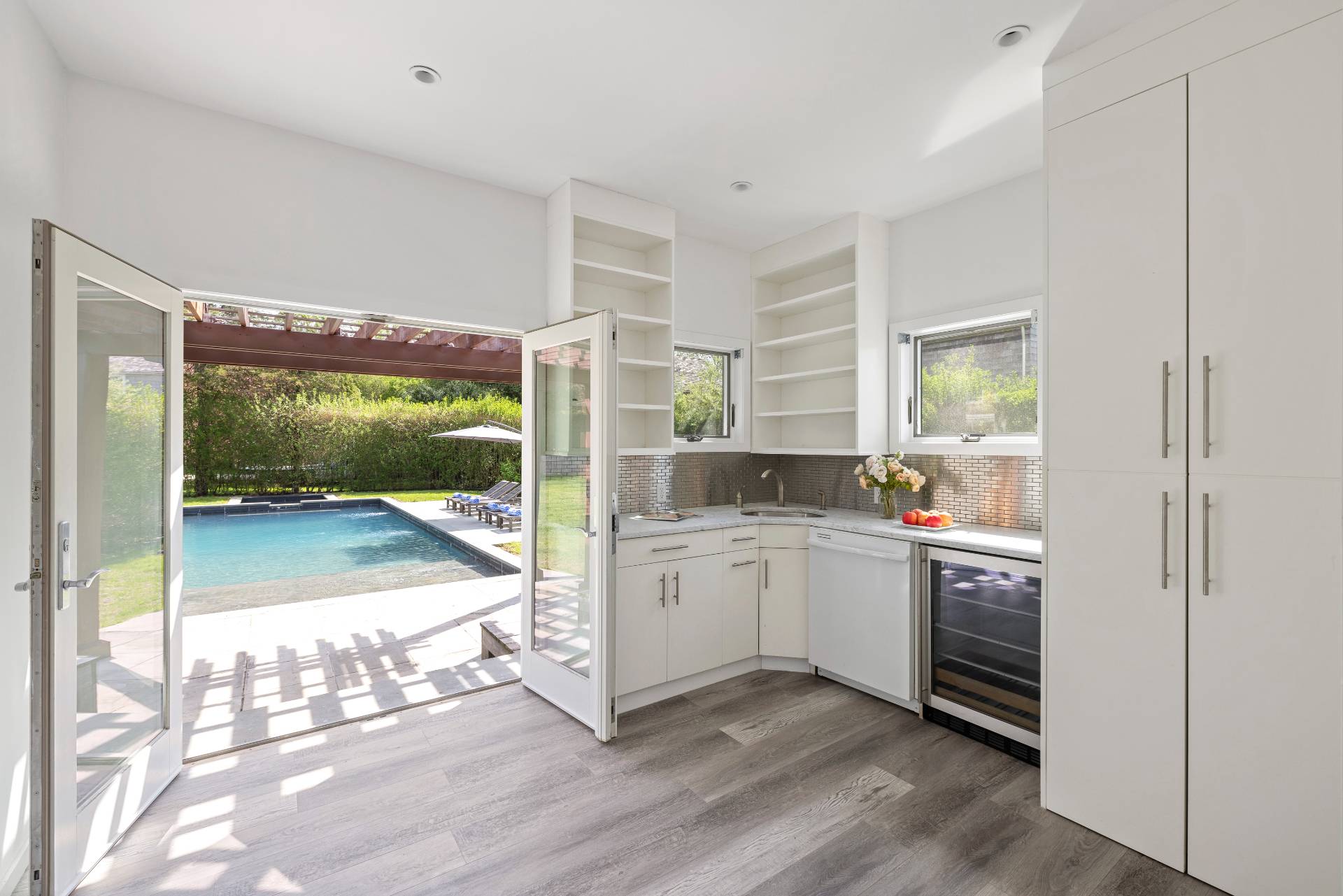 96 Audubon Avenue Bridgehampton, NY 11932 - Photo 22 of 25 a room with kitchen island a large window in it