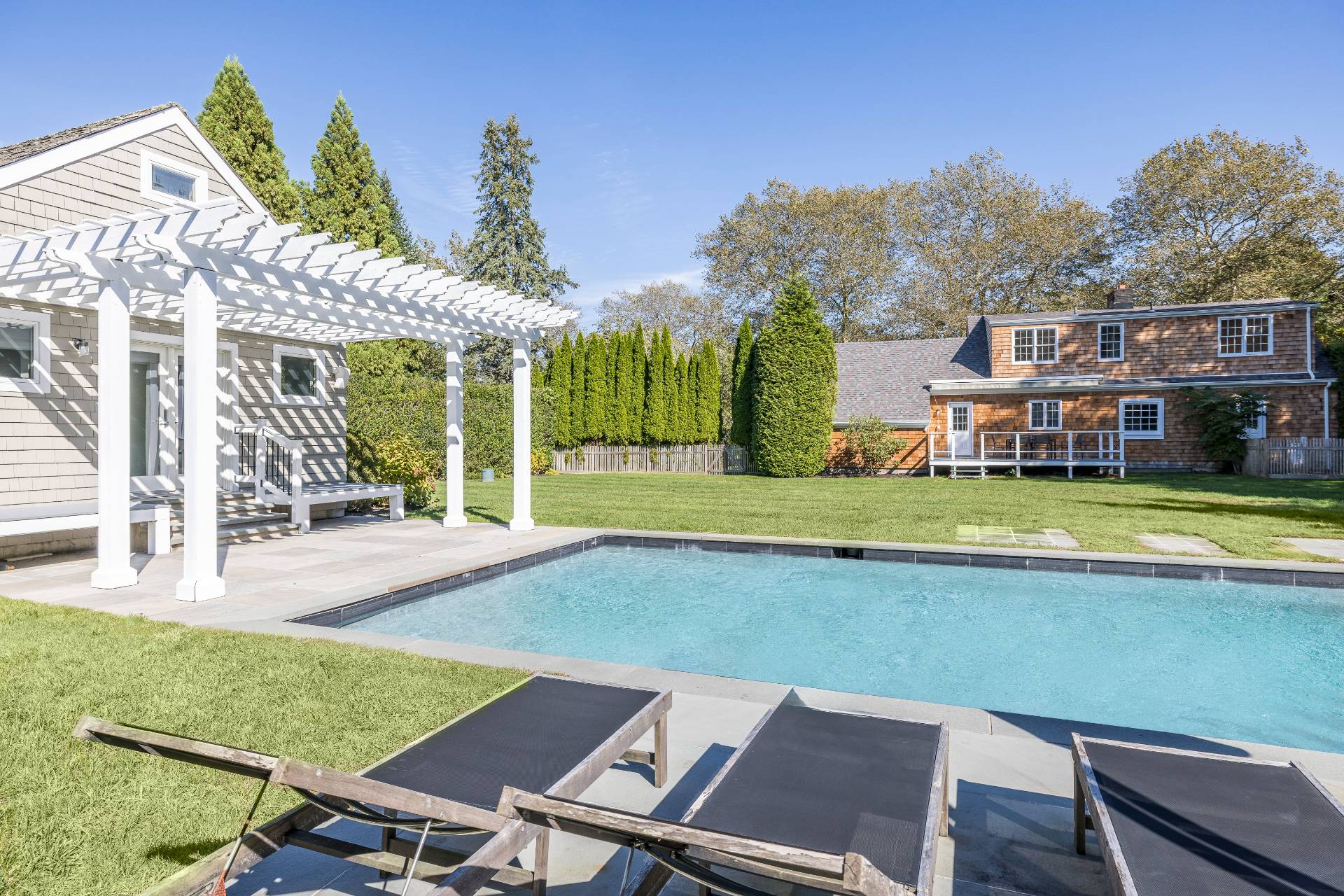 96 Audubon Avenue Bridgehampton, NY 11932 - Photo 25 of 25 a view of a house with swimming pool and a yard