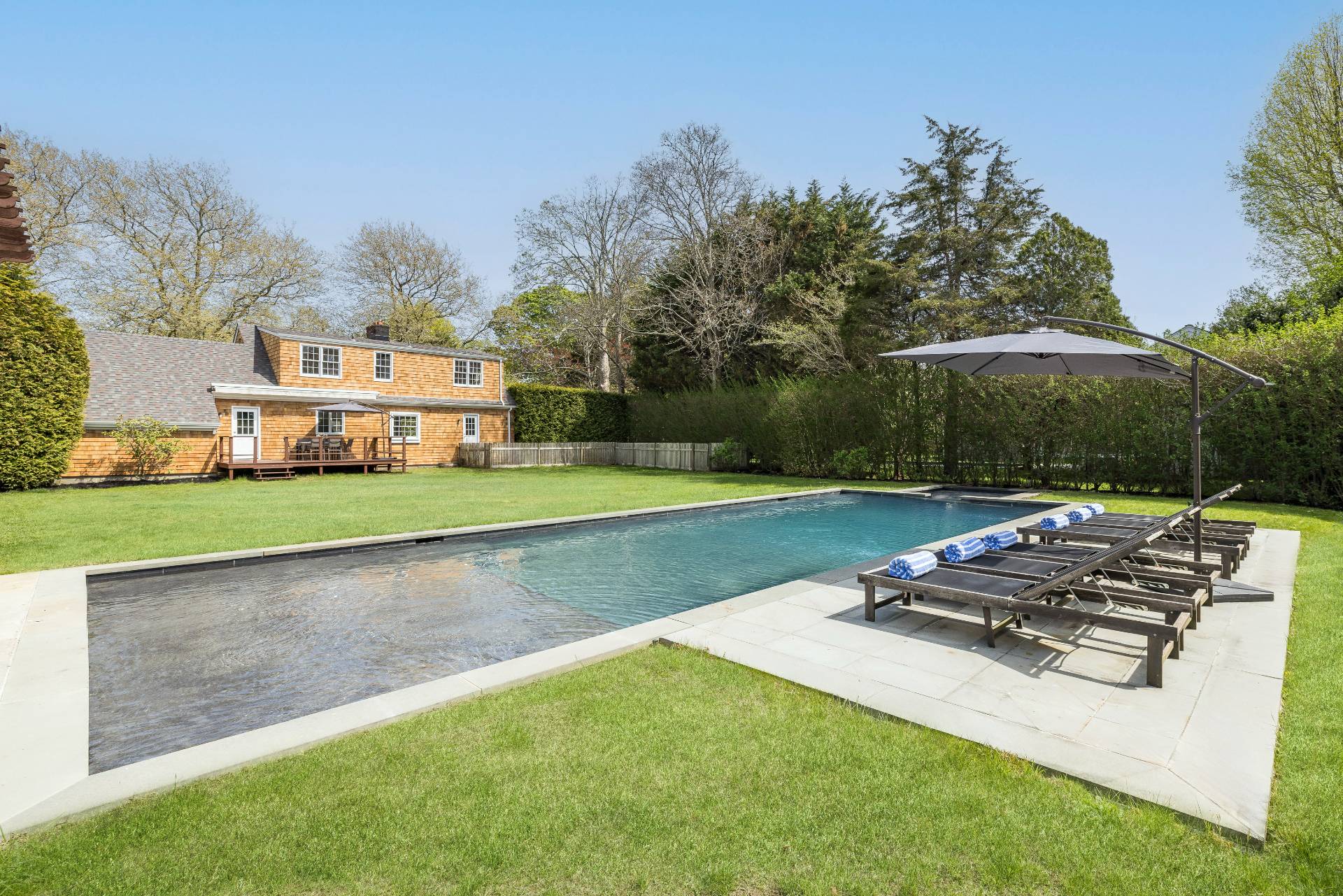 96 Audubon Avenue Bridgehampton, NY 11932 - Photo 5 of 25 a view of a house with backyard sitting area and garden
