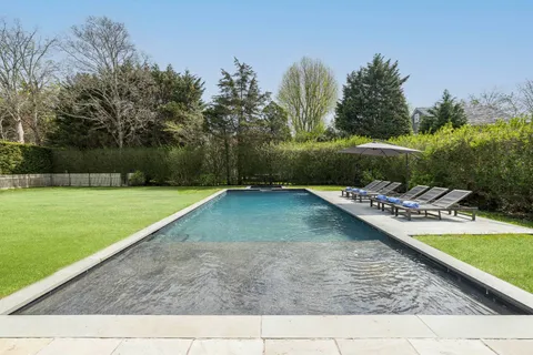 a view of a swimming pool with a yard