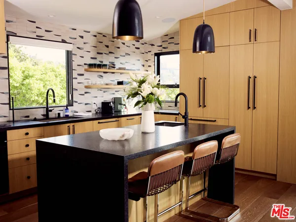 a kitchen with stainless steel appliances a sink and a large window
