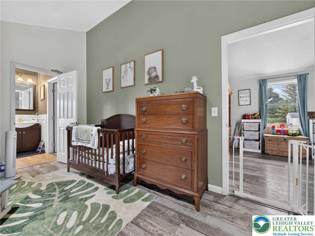 2628 Levans Road Coplay, PA 18037 - Photo 34 of 54 This tranquil space offers a crib and dresser, with wood-look flooring extending throughout.