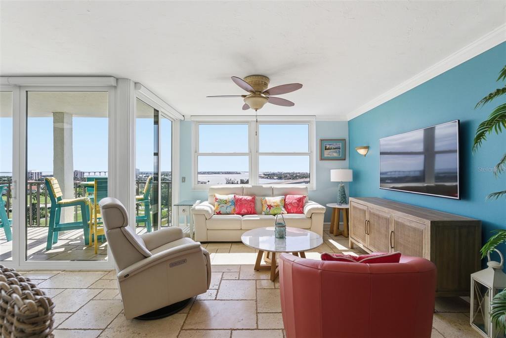 6265 Sun Boulevard, Unit 1204 St. Petersburg, FL 33715 - Photo 18 of 43 a living room with furniture a flat screen tv and a large window