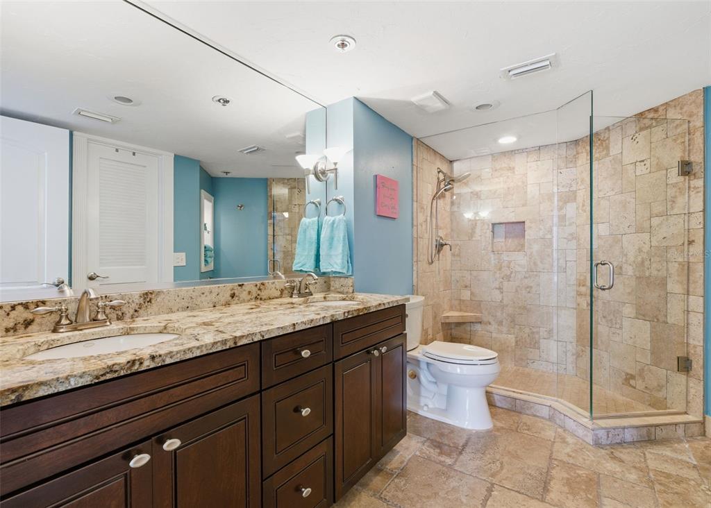 6265 Sun Boulevard, Unit 1204 St. Petersburg, FL 33715 - Photo 22 of 43 a bathroom with a granite countertop sink toilet and shower