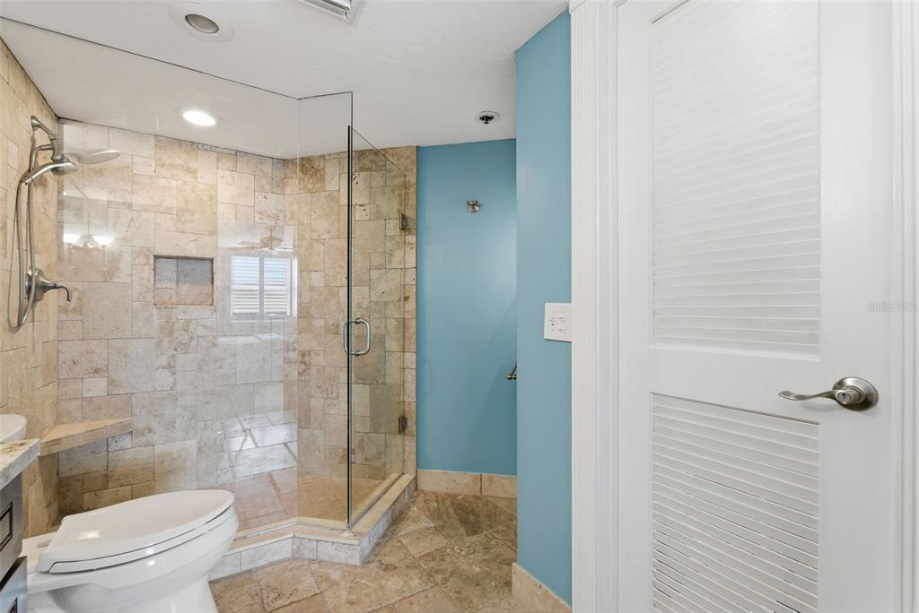 6265 Sun Boulevard, Unit 1204 St. Petersburg, FL 33715 - Photo 23 of 43 a bathroom with a shower a toilet and sink