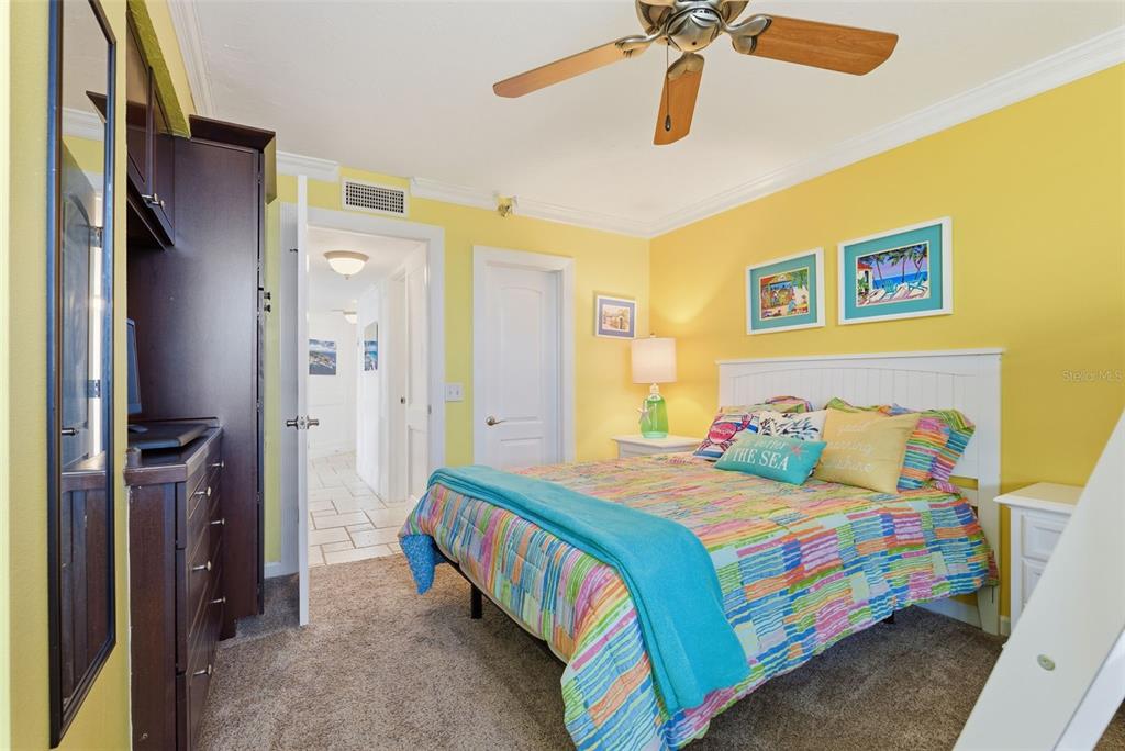 6265 Sun Boulevard, Unit 1204 St. Petersburg, FL 33715 - Photo 25 of 43 a bedroom with a bed and a chandelier