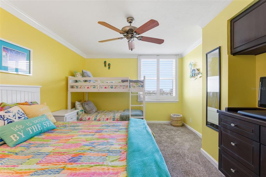 6265 Sun Boulevard, Unit 1204 St. Petersburg, FL 33715 - Photo 26 of 43 a bedroom with a bed and wooden floor