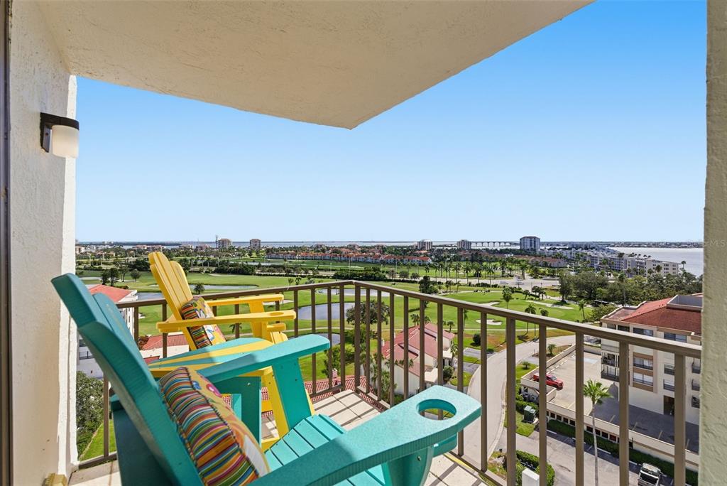 6265 Sun Boulevard, Unit 1204 St. Petersburg, FL 33715 - Photo 30 of 43 a view of a balcony with wooden chairs and ocean view
