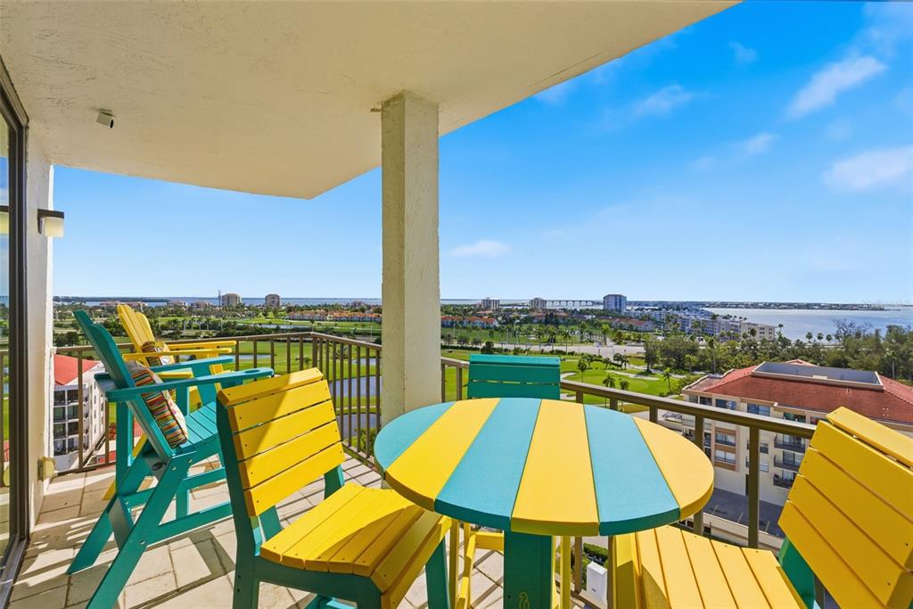 6265 Sun Boulevard, Unit 1204 St. Petersburg, FL 33715 - Photo 32 of 43 a view of a swimming pool with a lounge chairs