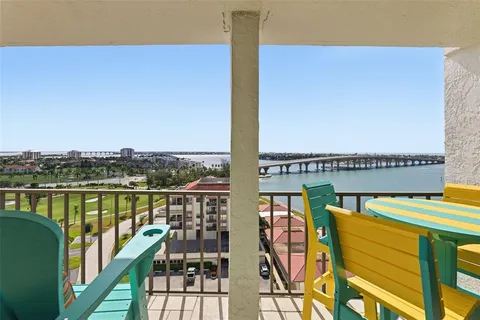 a view of a chairs and table in patio with a yard