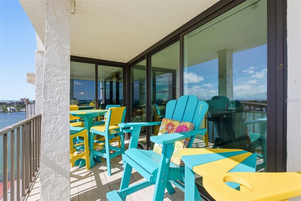 6265 Sun Boulevard, Unit 1204 St. Petersburg, FL 33715 - Photo 34 of 43 a view of a chairs and table in patio with a yard