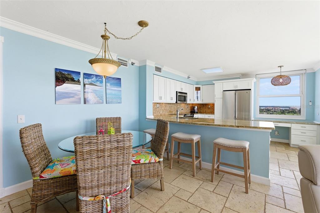 6265 Sun Boulevard, Unit 1204 St. Petersburg, FL 33715 - Photo 7 of 43 a outdoor kitchen with a dining table chairs and a sink