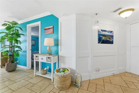 a living room with furniture and a dining table with kitchen appliances