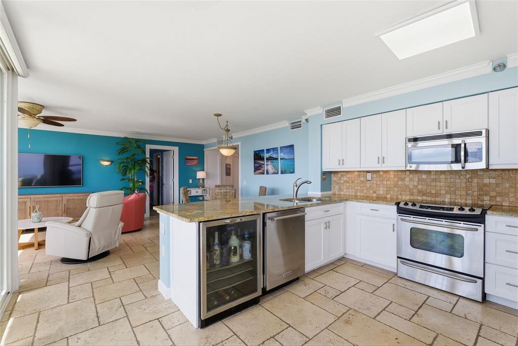 6265 Sun Boulevard, Unit 1204 St. Petersburg, FL 33715 - Photo 10 of 43 a kitchen with a stove top oven and cabinets