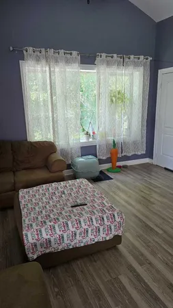 a dining room with furniture and wooden floor