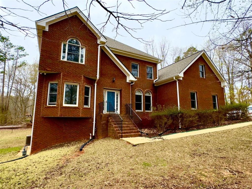 219 Deerhill Drive Bogart, GA 30622 - Photo 1 of 27 a front view of a house with a yard covered in snow