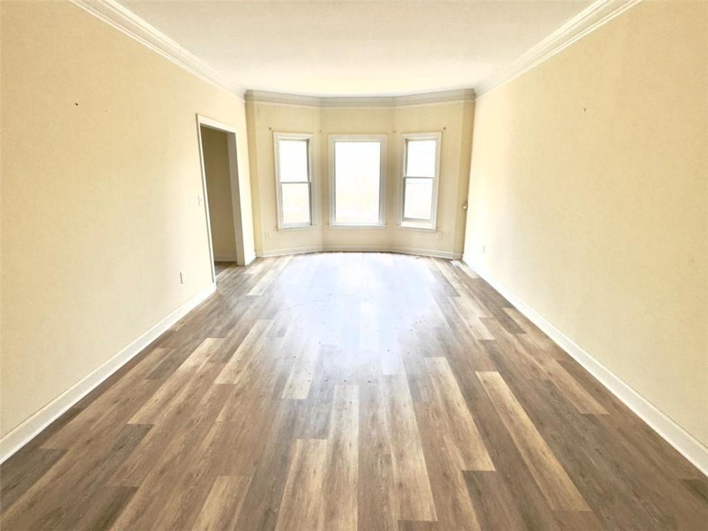 219 Deerhill Drive Bogart, GA 30622 - Photo 5 of 27 a view of an empty room with wooden floor and a window