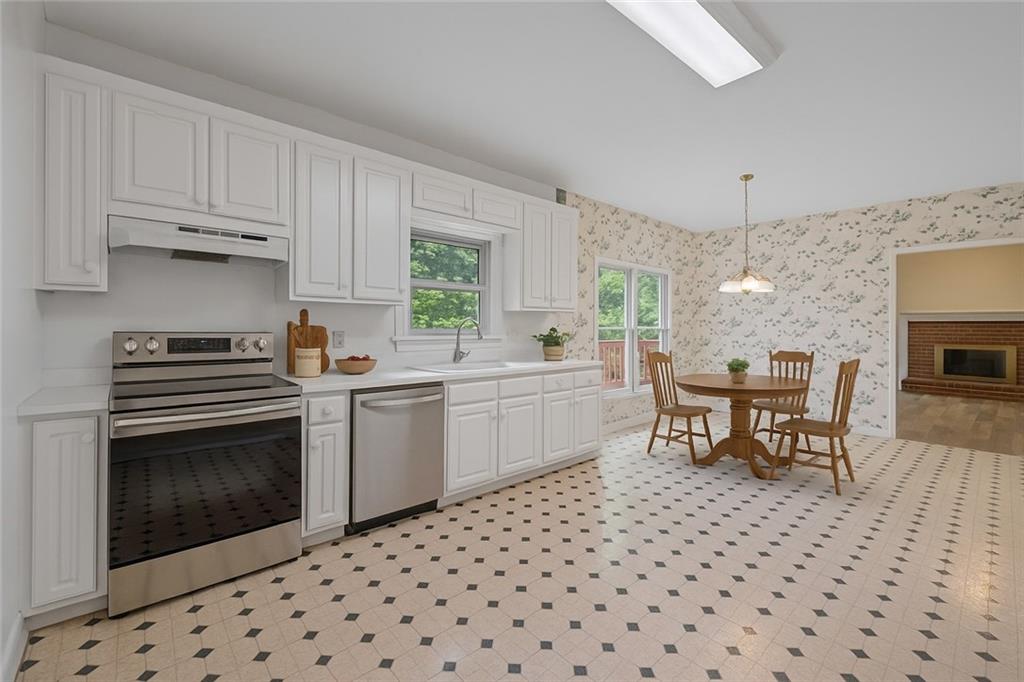 219 Deerhill Drive Bogart, GA 30622 - Photo 9 of 27 a kitchen with a sink a stove a microwave and cabinets