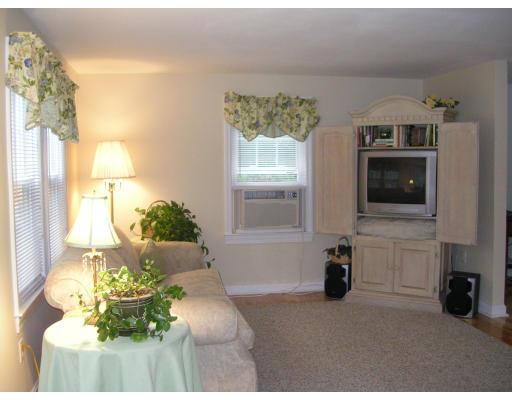 86 Maple Street Middleton, MA 01949 - Photo 11 of 24 a living room with fireplace furniture and a flat screen tv