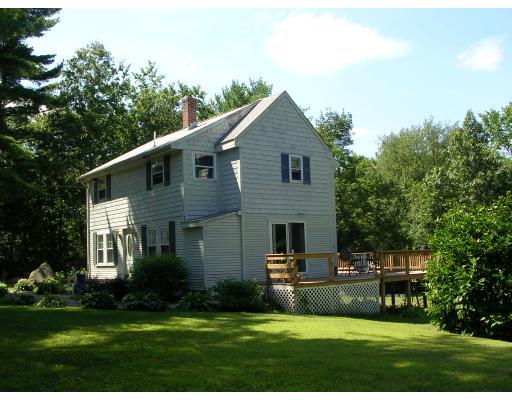86 Maple Street Middleton, MA 01949 - Photo 2 of 24 a front view of a house with a garden and yard