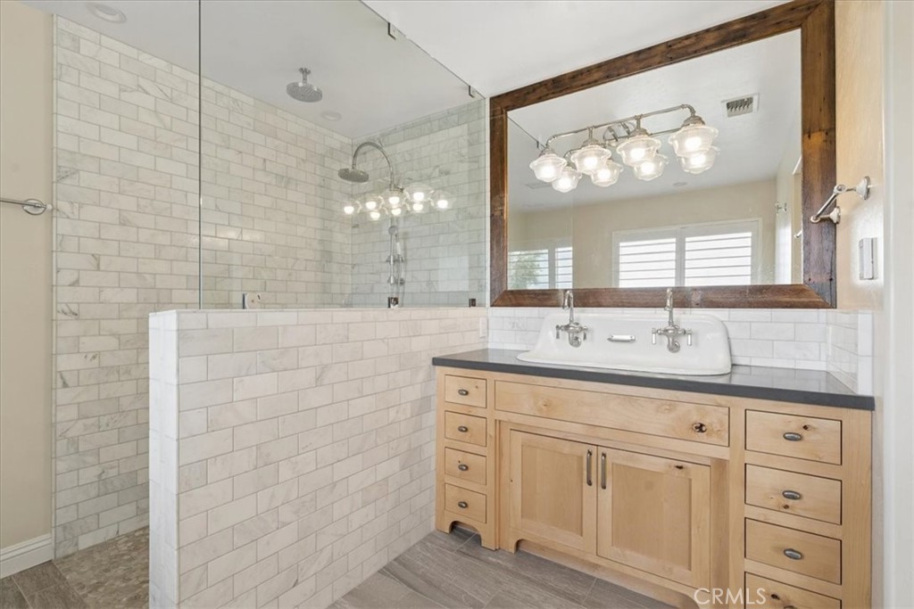5565 High Ridge Road Paso Robles, CA 93446 - Photo 34 of 73 a bathroom with a double vanity sink and a mirror