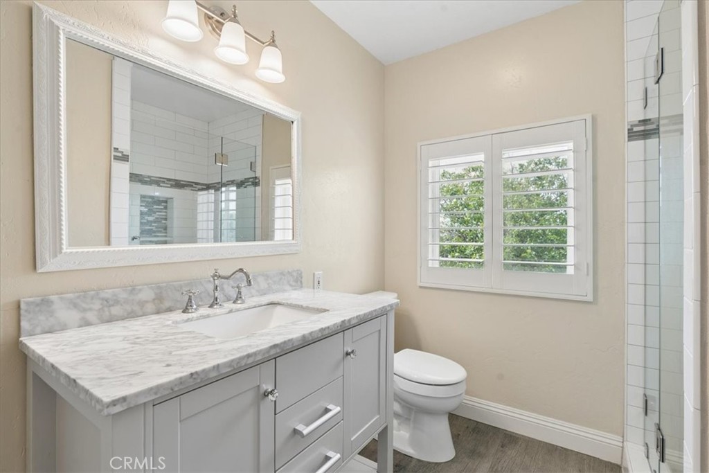 5565 High Ridge Road Paso Robles, CA 93446 - Photo 43 of 73 a bathroom with a granite countertop sink a toilet and a mirror
