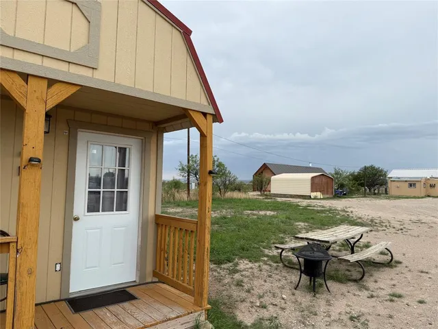 a backyard of a house with outdoor seating