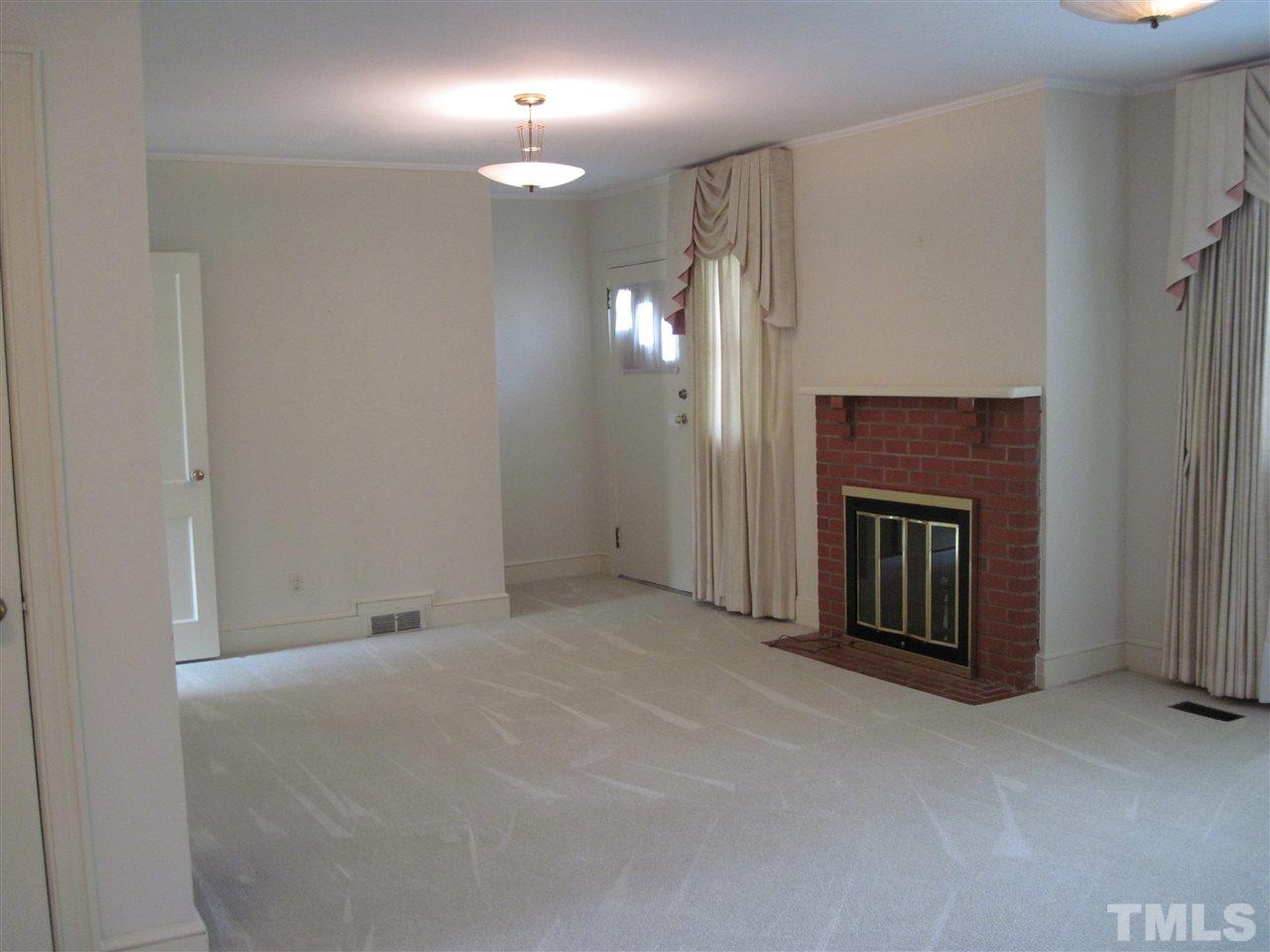 4009 St James Church Road Raleigh, NC 27604 - Photo 2 of 17 a view of a livingroom with a fireplace