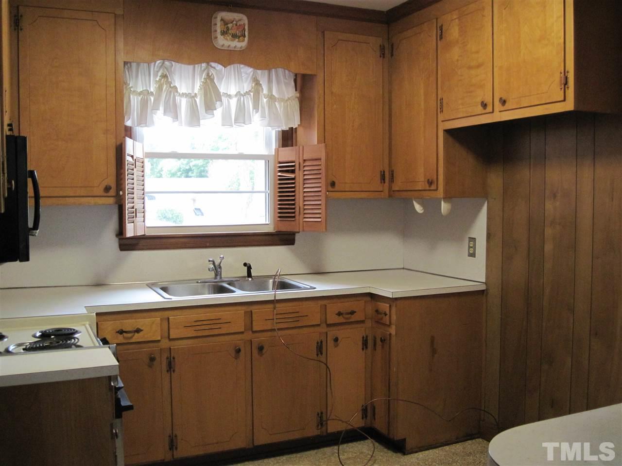 4009 St James Church Road Raleigh, NC 27604 - Photo 7 of 17 a utility room with cabinets washer and dryer