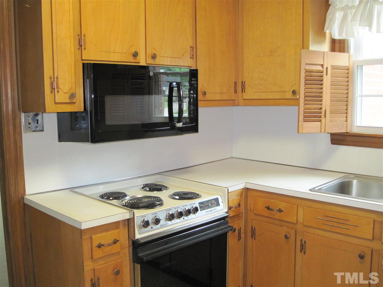 4009 St James Church Road Raleigh, NC 27604 - Photo 8 of 17 a kitchen with a stove and a microwave
