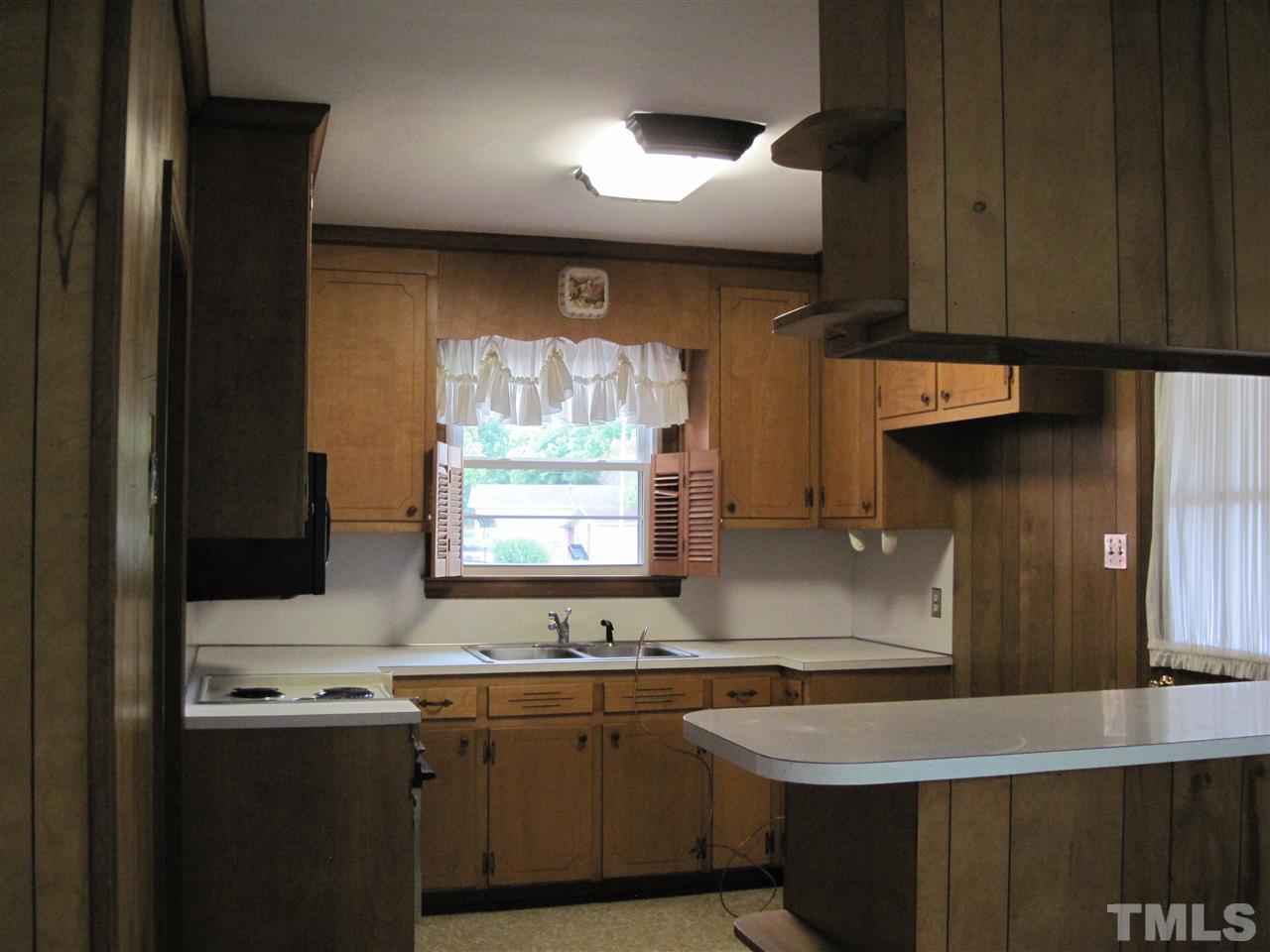 4009 St James Church Road Raleigh, NC 27604 - Photo 10 of 17 a kitchen with stainless steel appliances a sink stove and cabinets