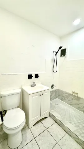 a bathroom with a sink a toilet and bathtub