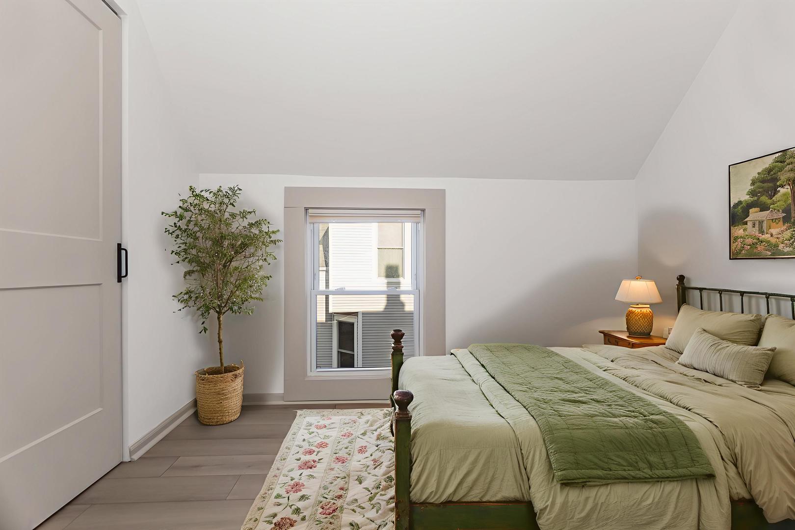 2846 North Troy Street, Unit 2 Chicago, IL 60618 - Photo 13 of 18 a bedroom with a bed and a potted plant