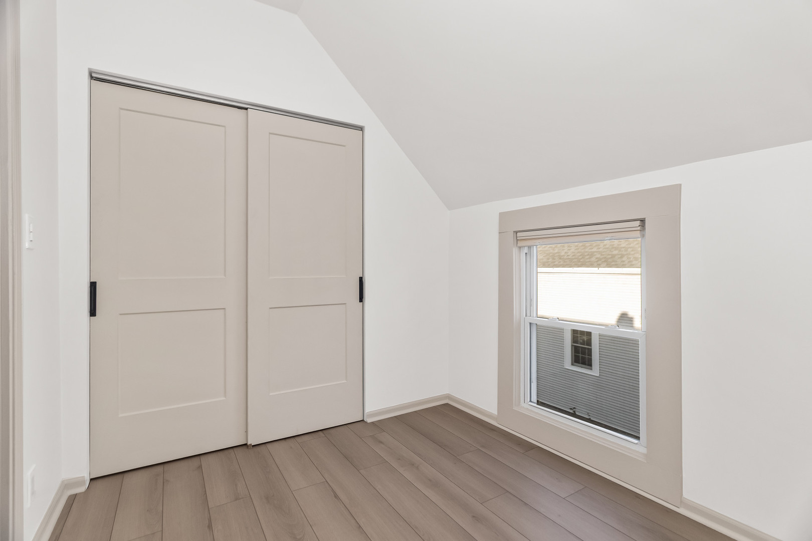 2846 North Troy Street, Unit 2 Chicago, IL 60618 - Photo 14 of 18 a view of an empty room with wooden floor and closet