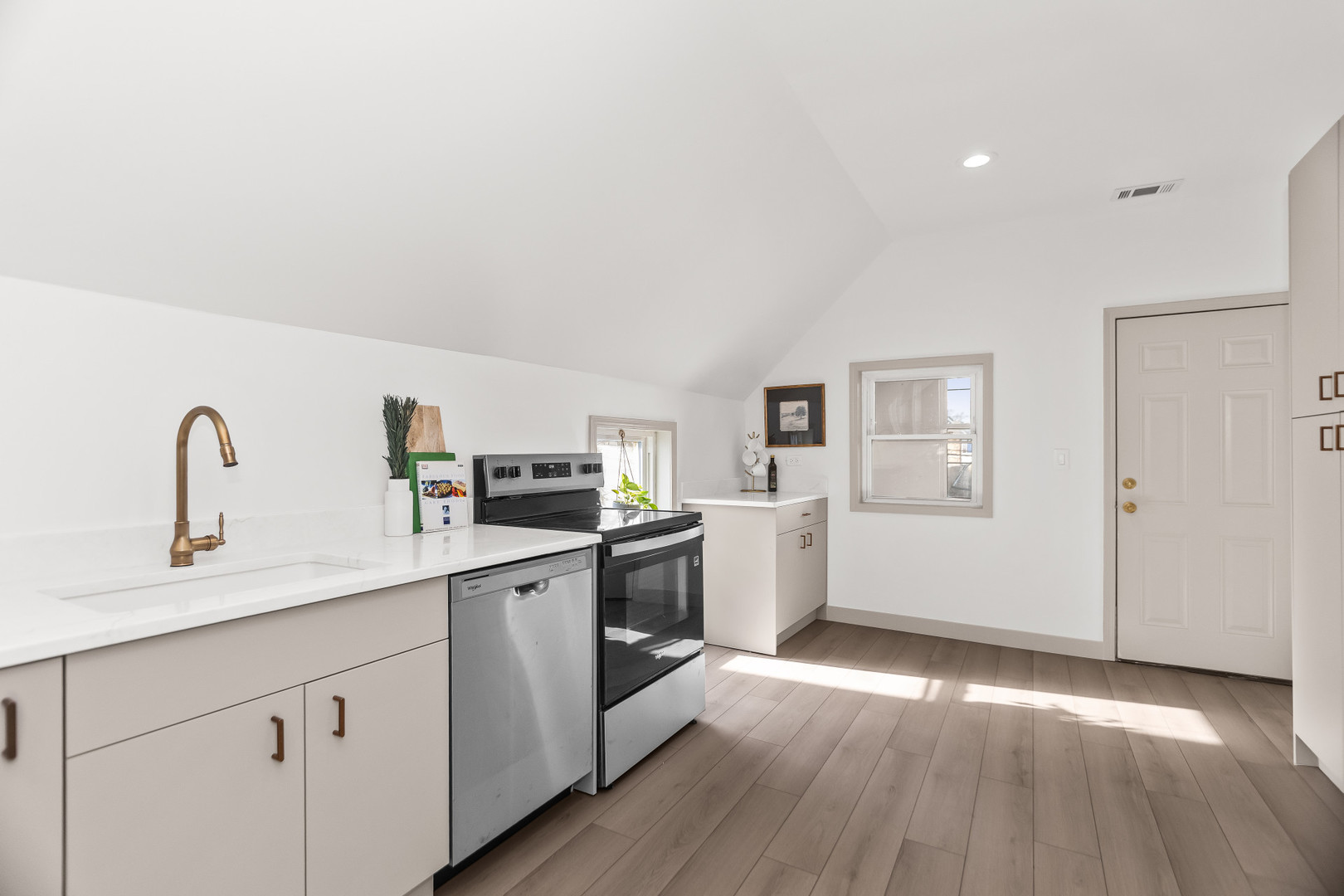 2846 North Troy Street, Unit 2 Chicago, IL 60618 - Photo 8 of 18 a kitchen with a sink cabinets and wooden floor